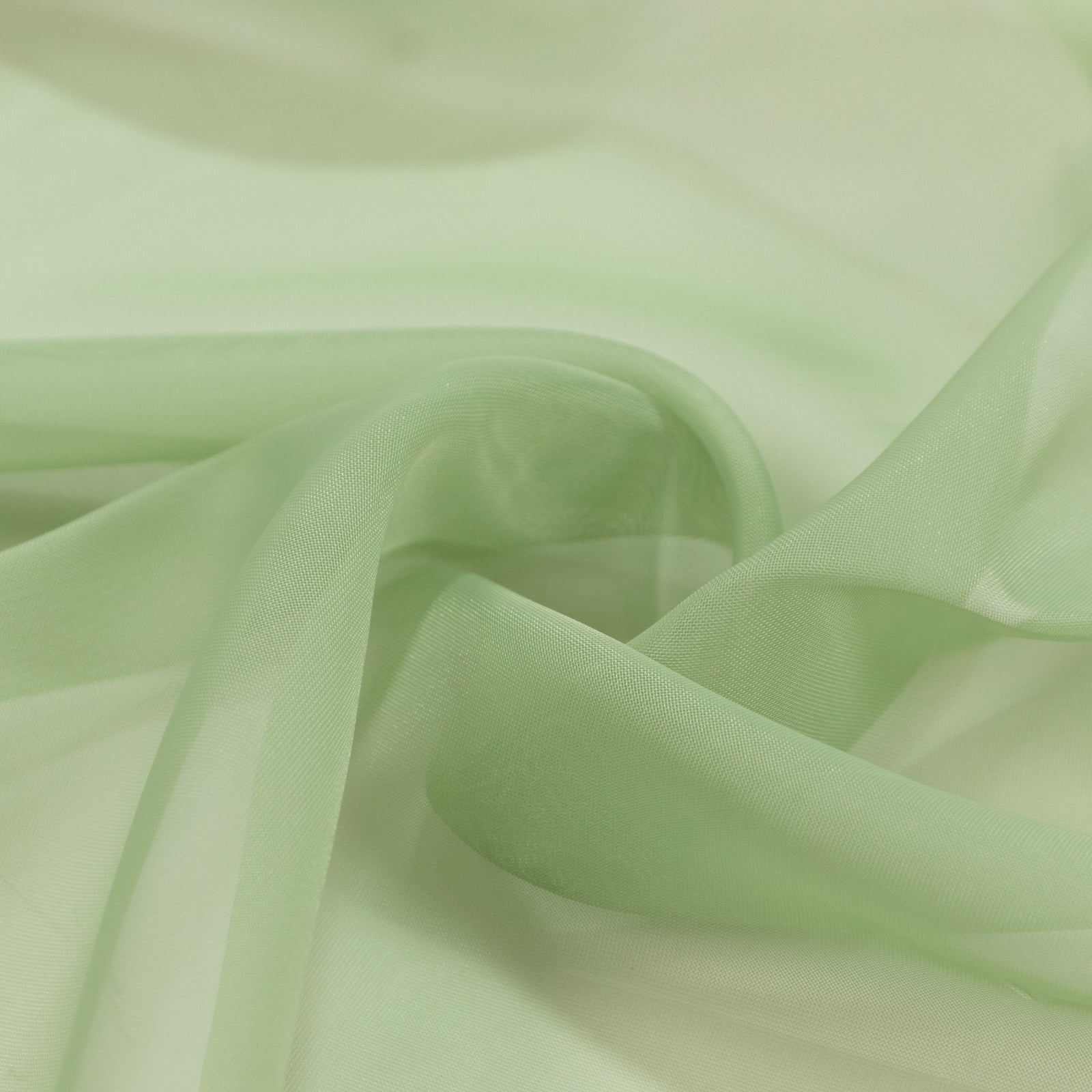Sage green chiffon backdrop curtain panel fabric close-up. #whtbkgd