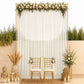 Ivory chiffon backdrop curtain panel with floral decoration and gold chairs.