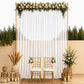 White chiffon backdrop curtain panel with floral decor and gold chairs.