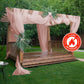 Dusty rose chiffon curtain panel draping a wooden pergola in a garden setting.