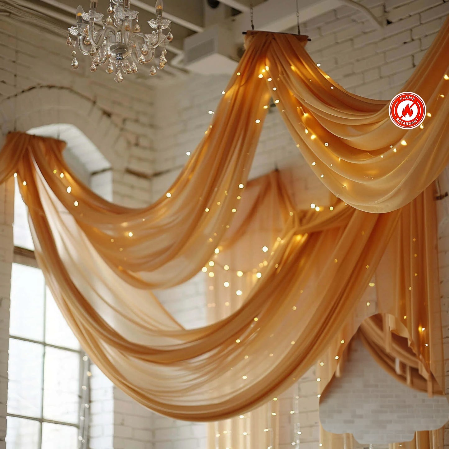 Gold chiffon curtain panel draping elegantly with lights in a bright setting.