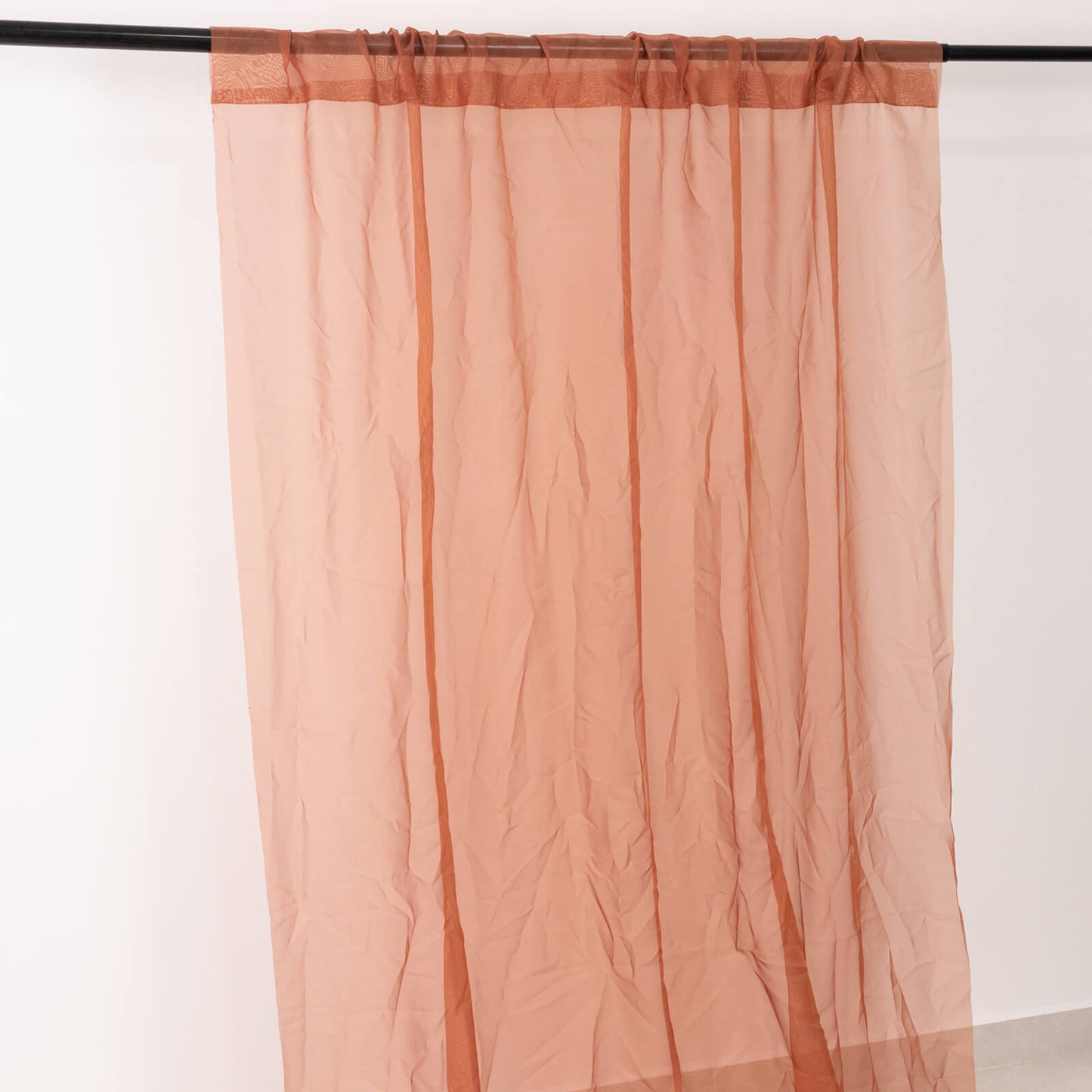 Terracotta chiffon curtain panel, durable and flame resistant.