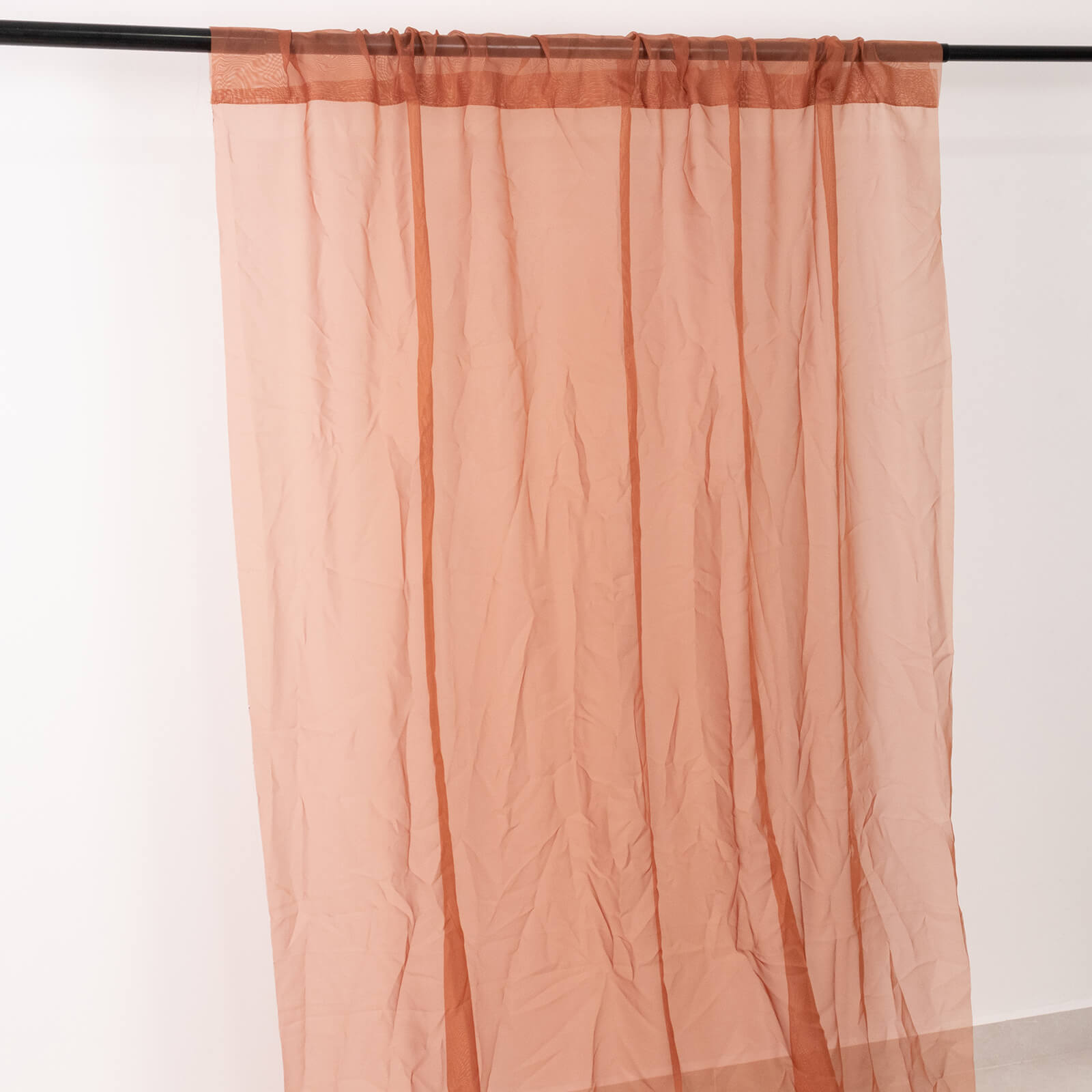 Terracotta chiffon curtain panel, durable and flame resistant.