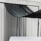 Black chiffon curtain panel draping elegantly in a bright room.