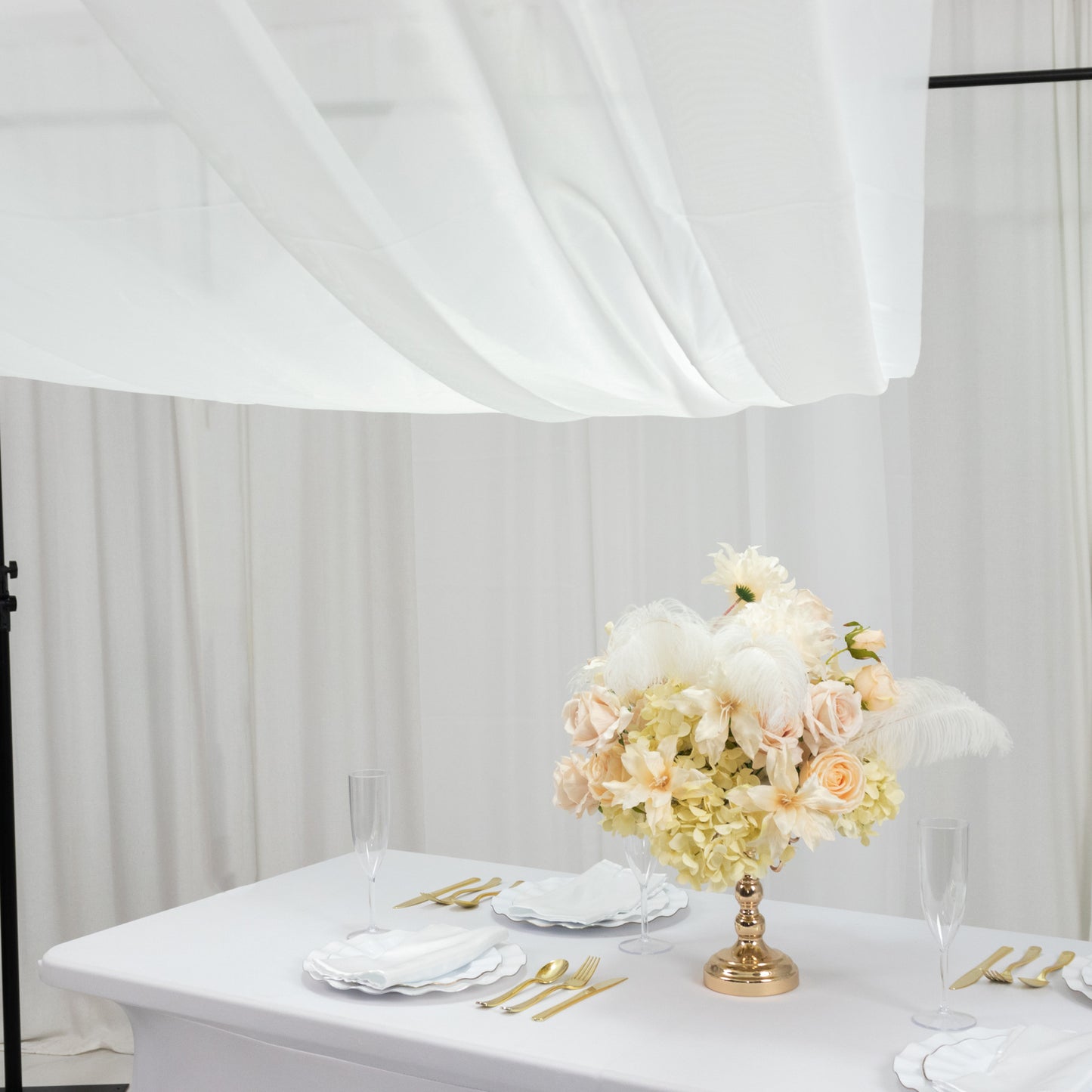 Ivory chiffon curtain panel draped elegantly over a table setting.