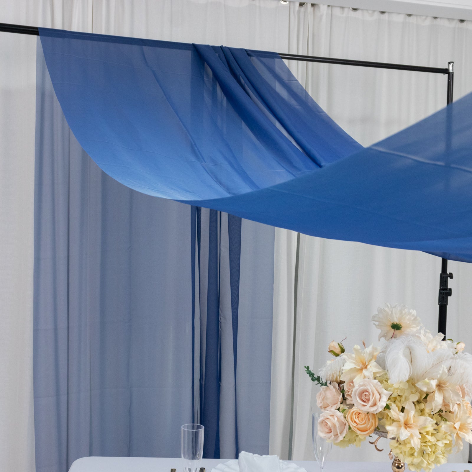 Navy blue chiffon curtain panel draped elegantly as a backdrop.