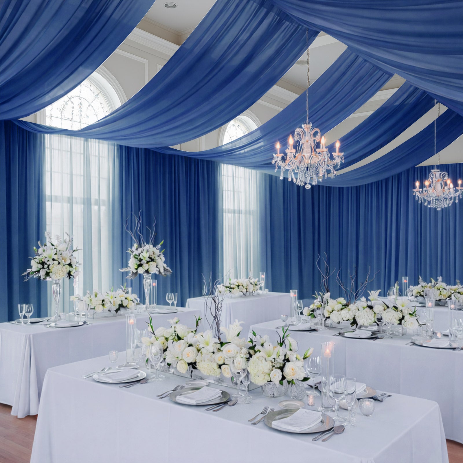 Navy blue chiffon curtain panel draped elegantly in a decorated event space.