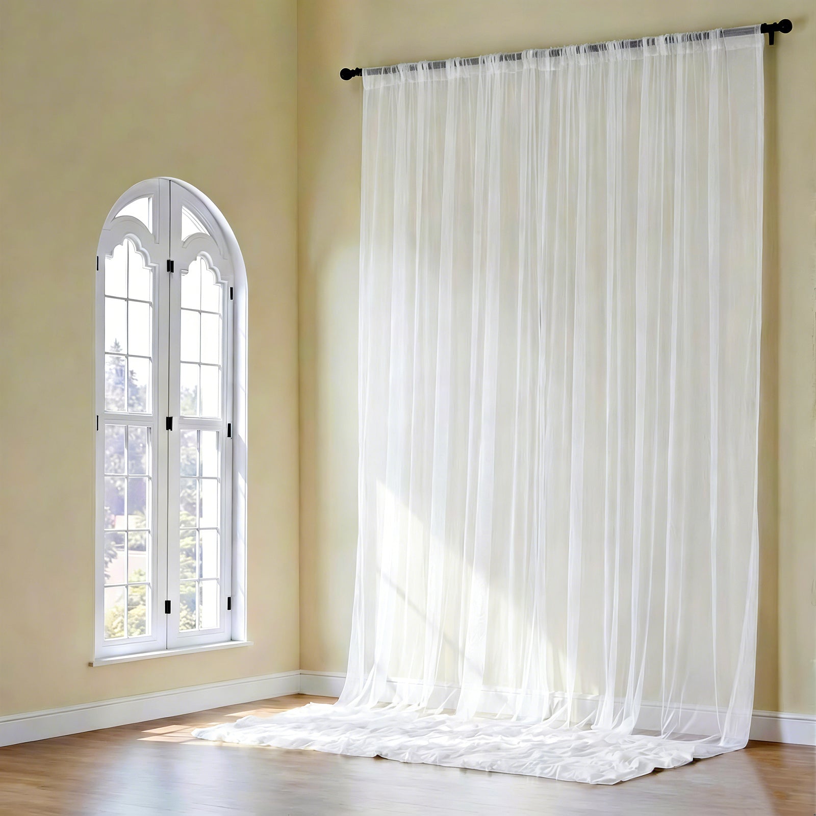 White chiffon curtain panel, durable and flame resistant, draped elegantly.