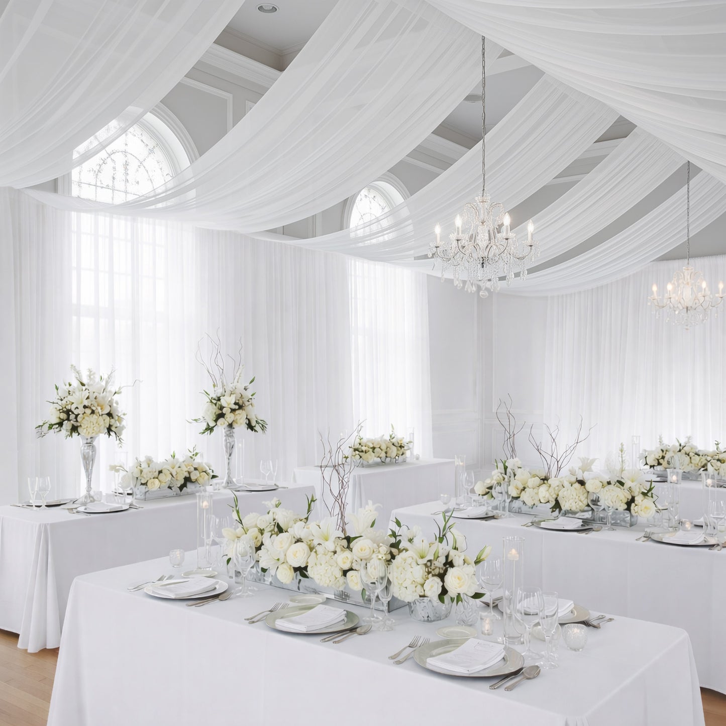 White chiffon curtain panel backdrop and ceiling drape in a bright, elegant setting.