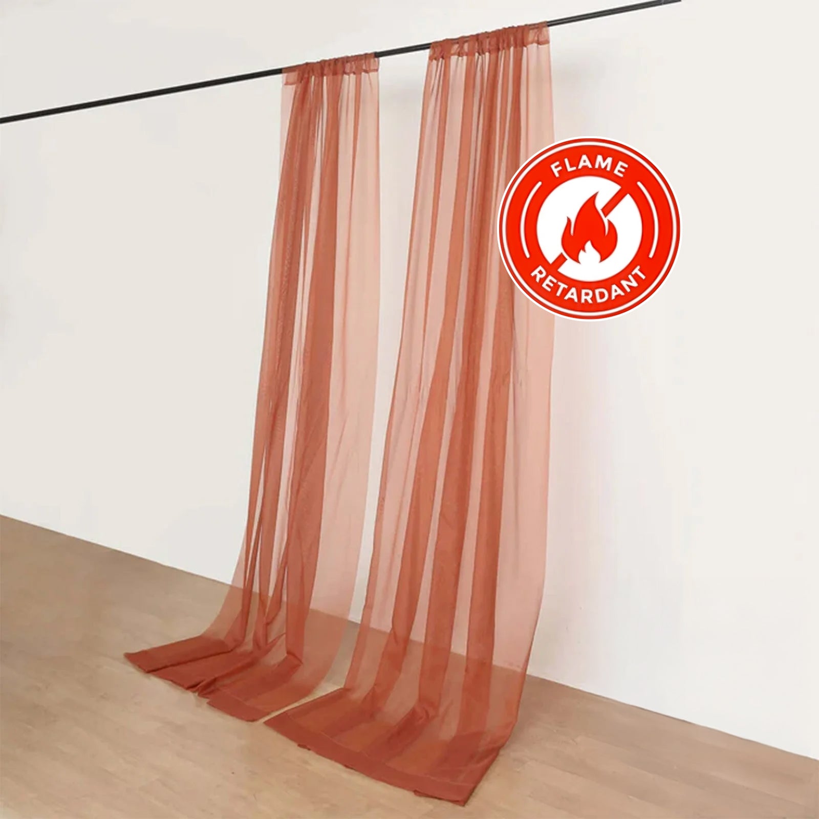 Terracotta sheer chiffon backdrop drape curtains on a rod.