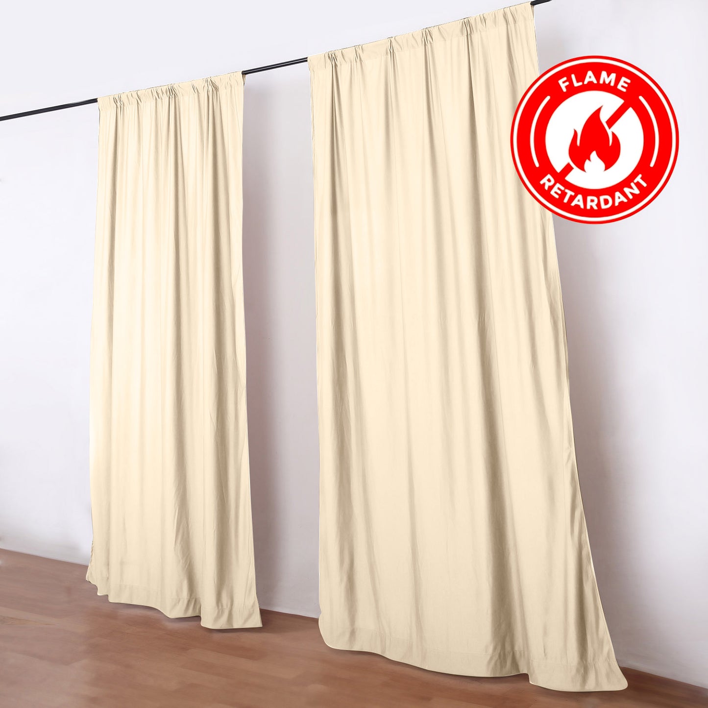 Beige flame-resistant backdrop drape curtains on a rod.