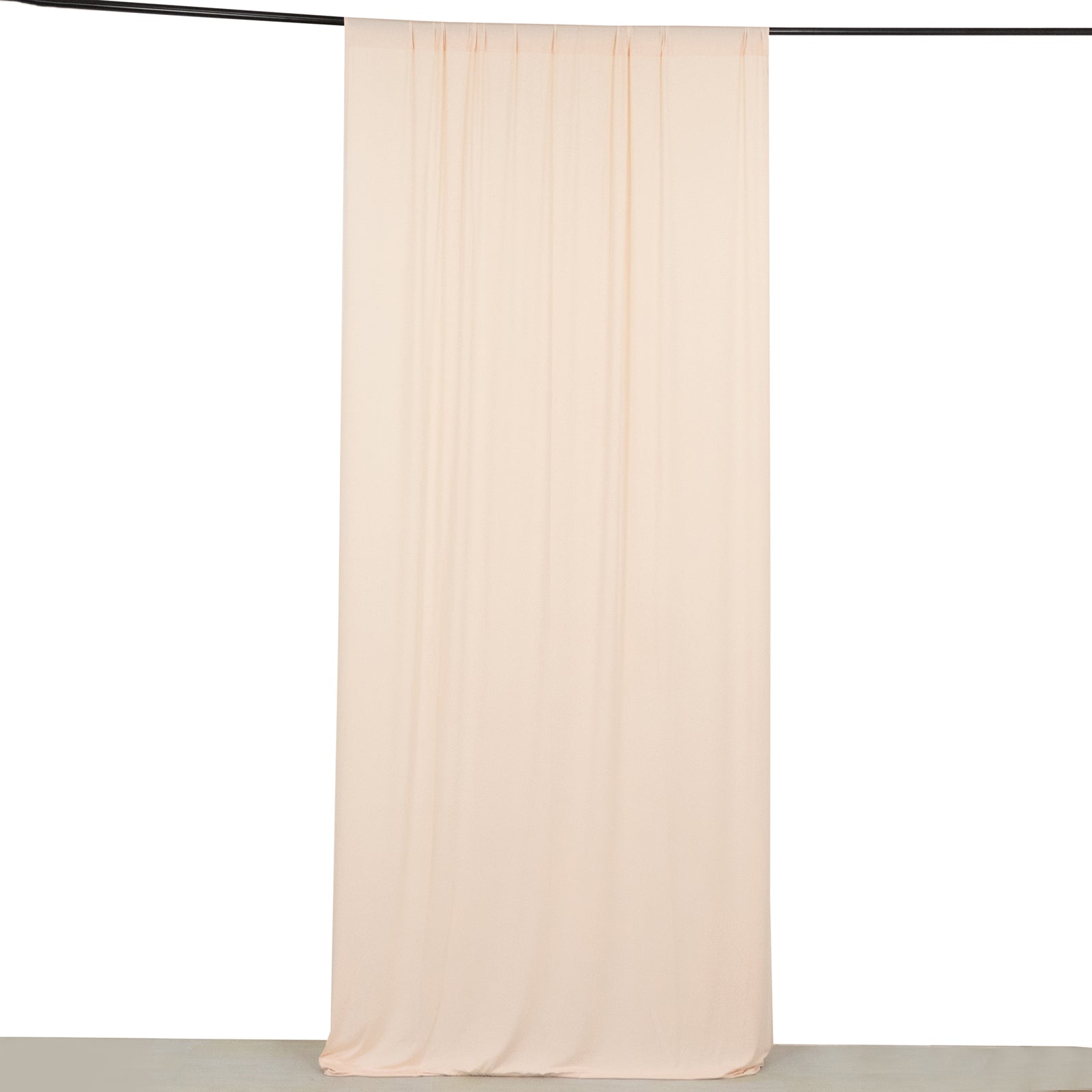 Blush 4-way stretch spandex event curtain drapes hanging on a rod.