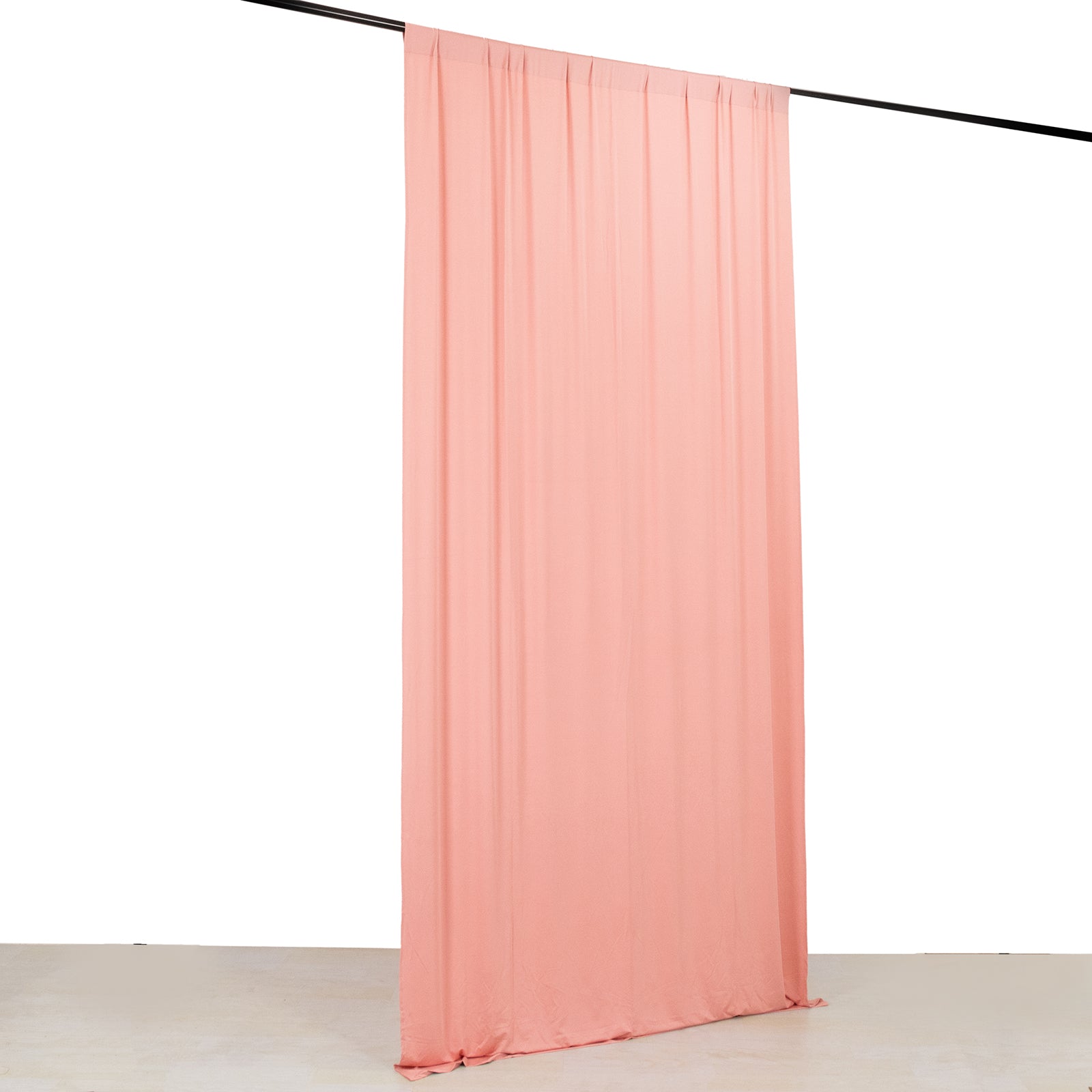 Dusty rose 4-way stretch spandex event curtain drapes hanging on a rod.