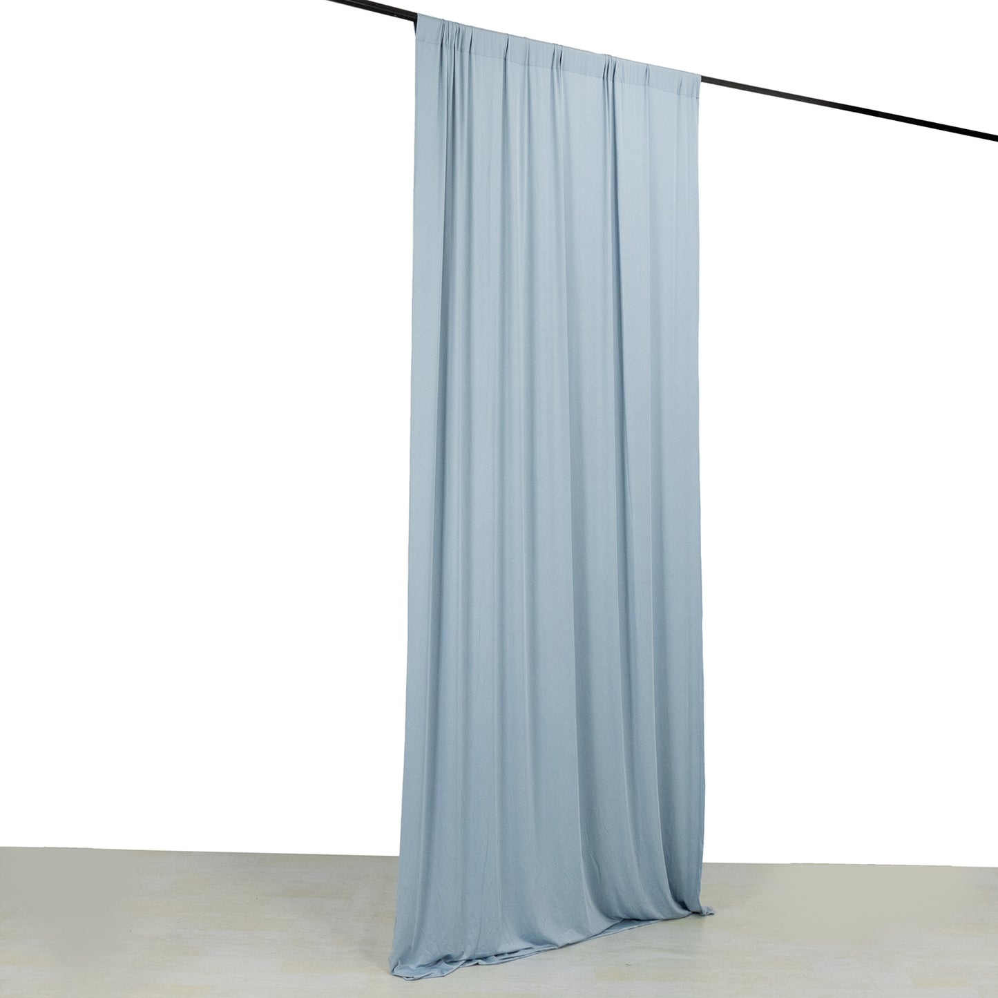 Dusty blue 4-way stretch spandex event curtain drapes on a rod.