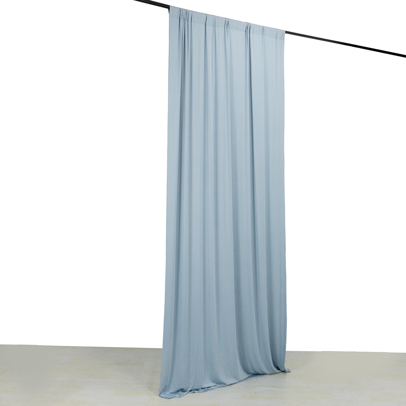 Dusty blue 4-way stretch spandex event curtain drapes on a rod.