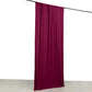 Burgundy 4-way stretch spandex event curtain drapes hanging on a rod.