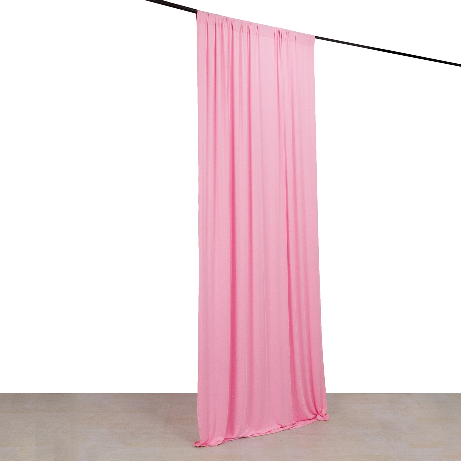 Pink 4-way stretch spandex event curtain drapes on a rod.