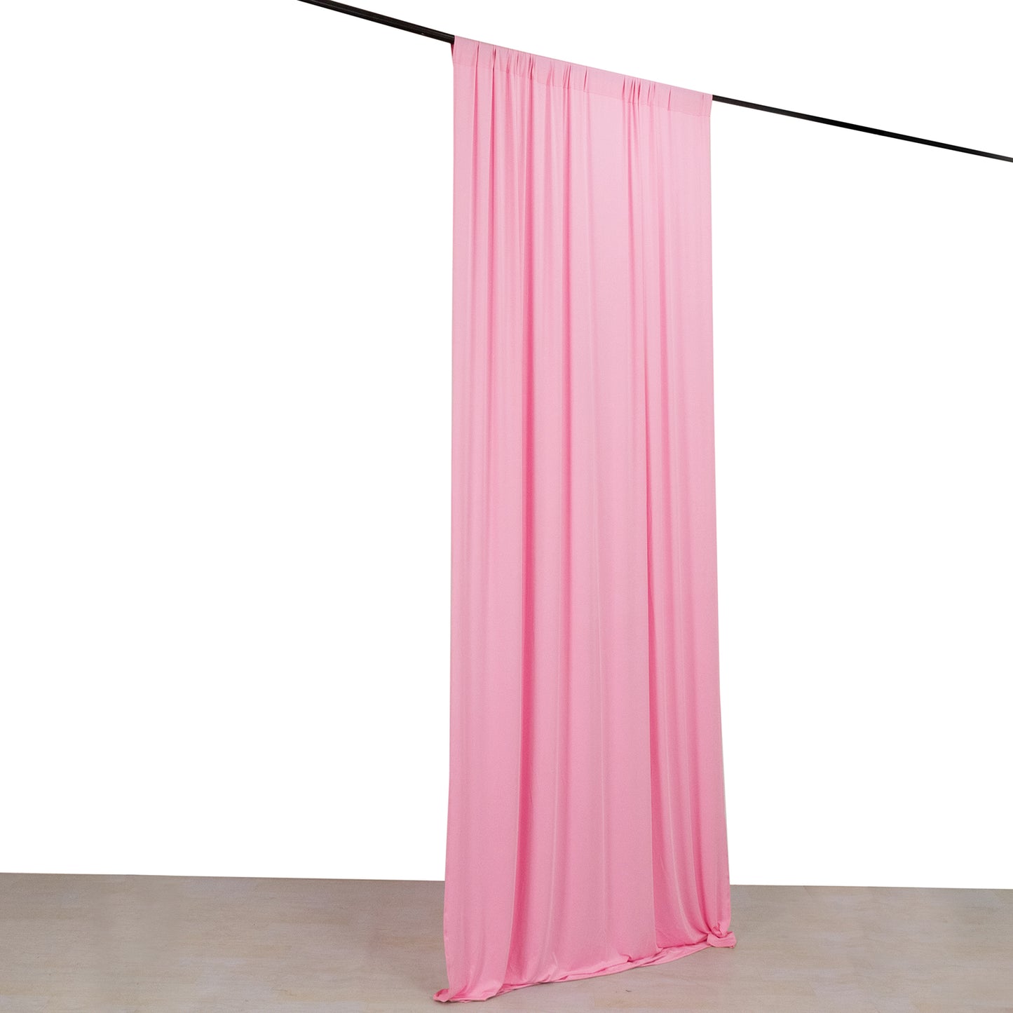 Pink 4-way stretch spandex event curtain drapes on a rod.