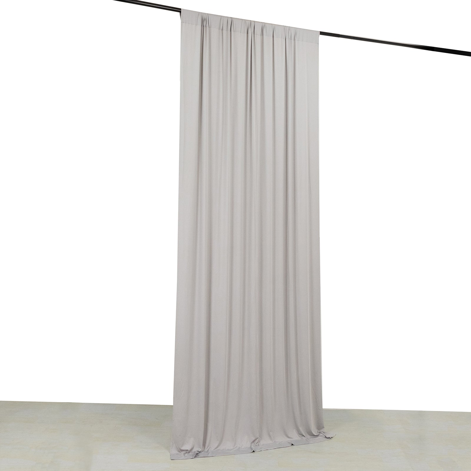 Silver 4-way stretch spandex event curtain drapes hanging on a rod.