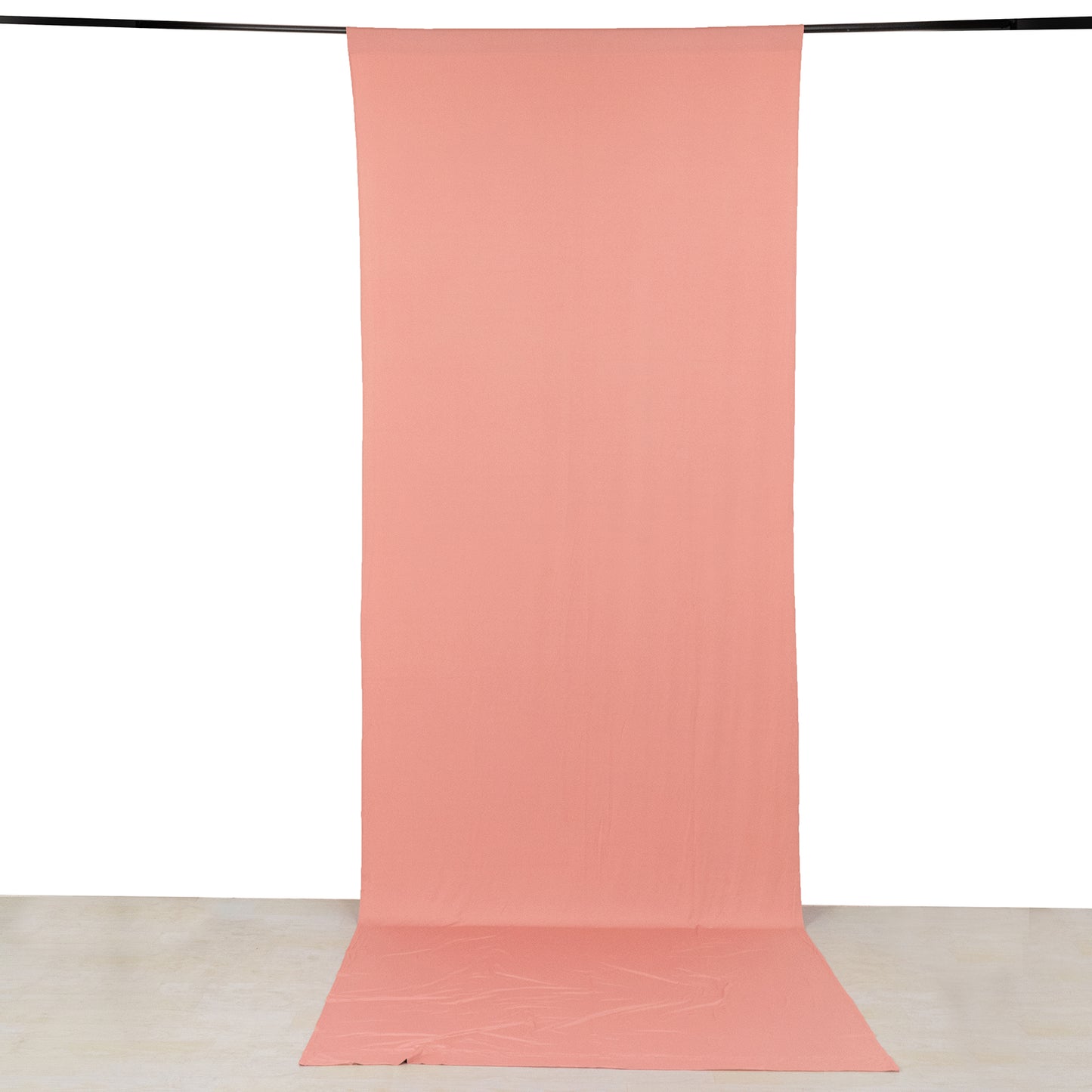 Dusty rose 4-way stretch spandex event curtain drapes on a backdrop.