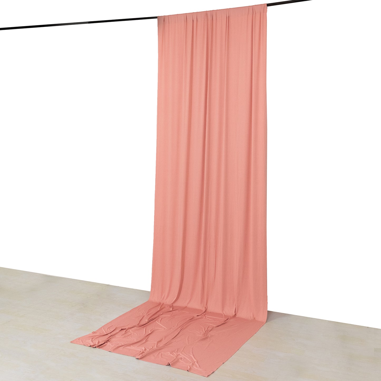 Dusty rose 4-way stretch spandex event curtain drapes on a rod.