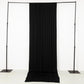 Black 4-way stretch spandex event curtain drapes on a backdrop frame.