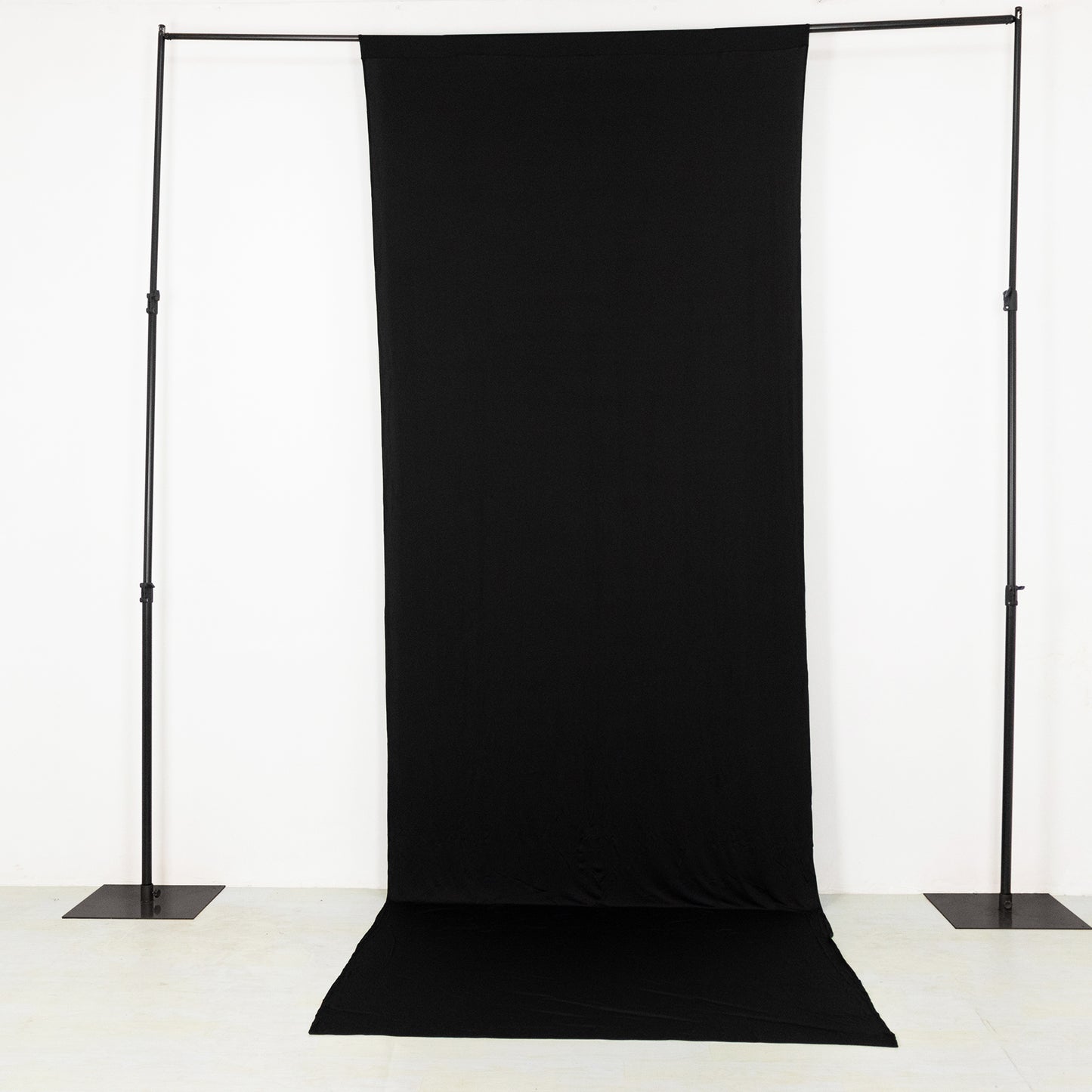 Black 4-way stretch spandex backdrop curtain drape for events.