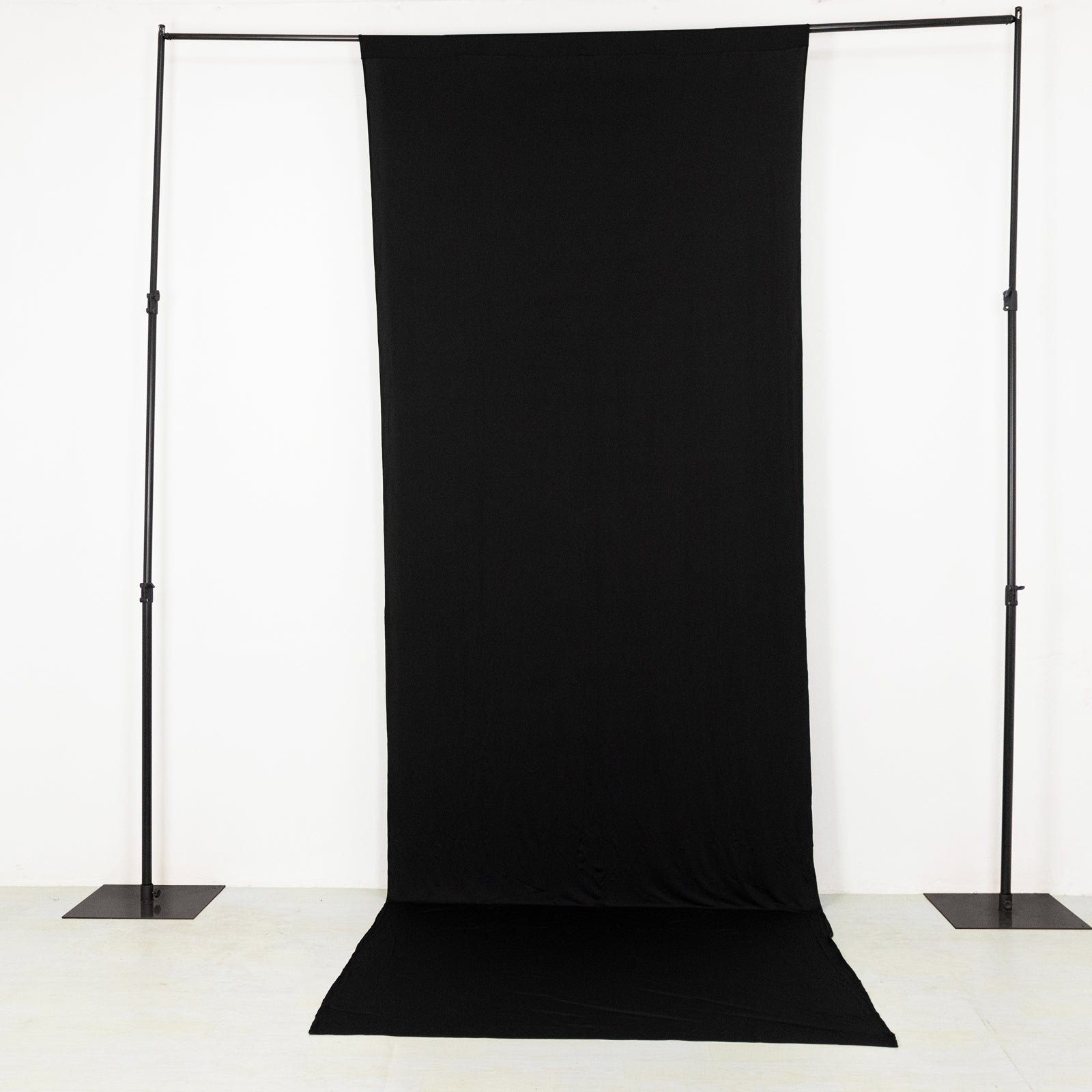 Black 4-way stretch spandex backdrop curtain drape for events.