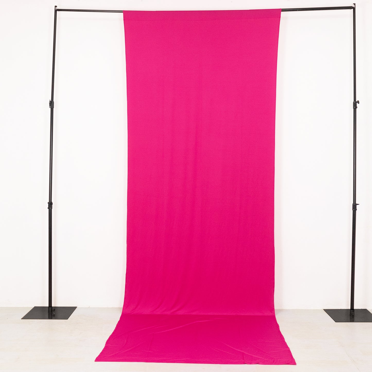 Fuchsia 4-way stretch spandex backdrop drape on a black frame.
