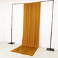 Gold 4-way stretch spandex event curtain drapes on a backdrop stand.