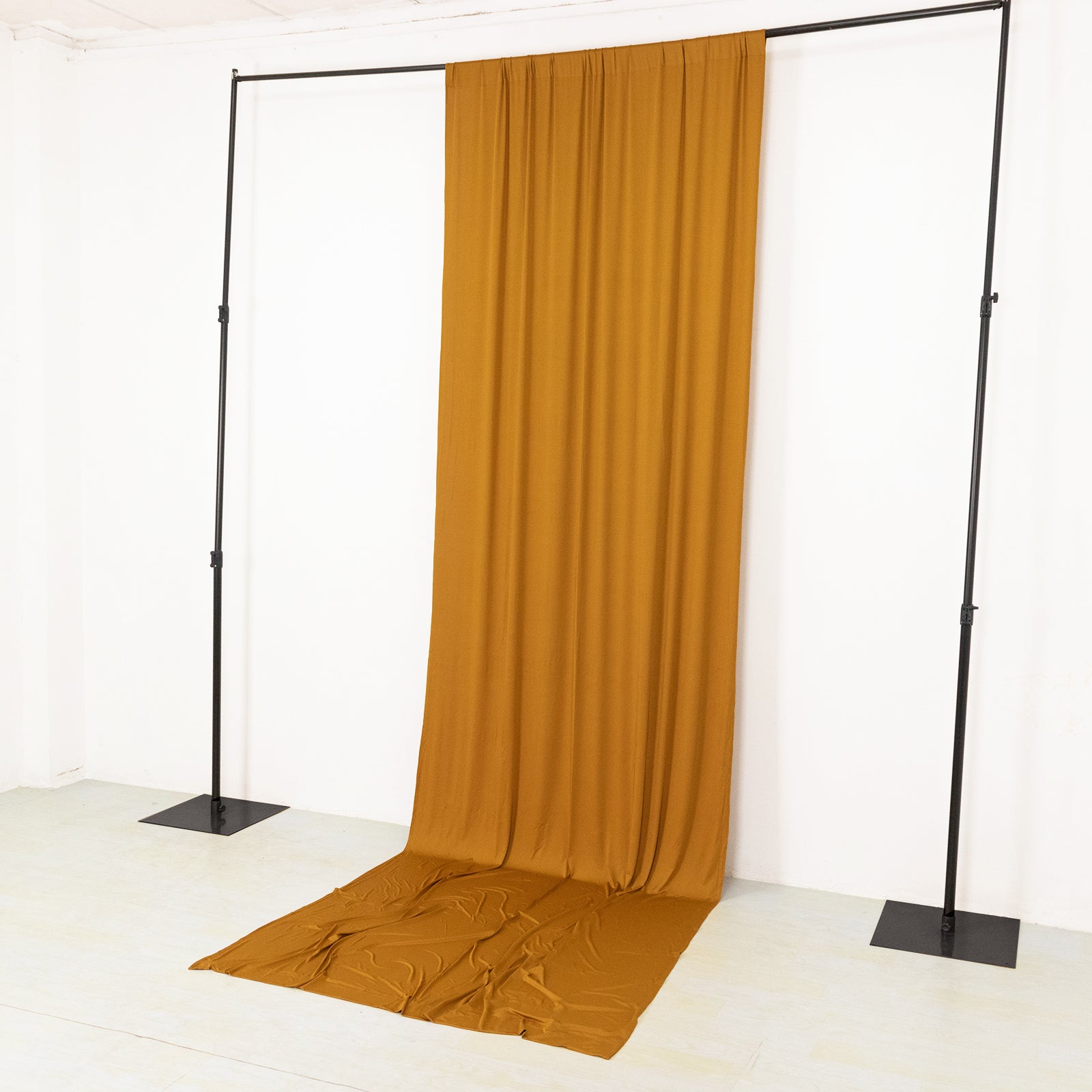 Gold 4-way stretch spandex event curtain drapes on a backdrop stand.