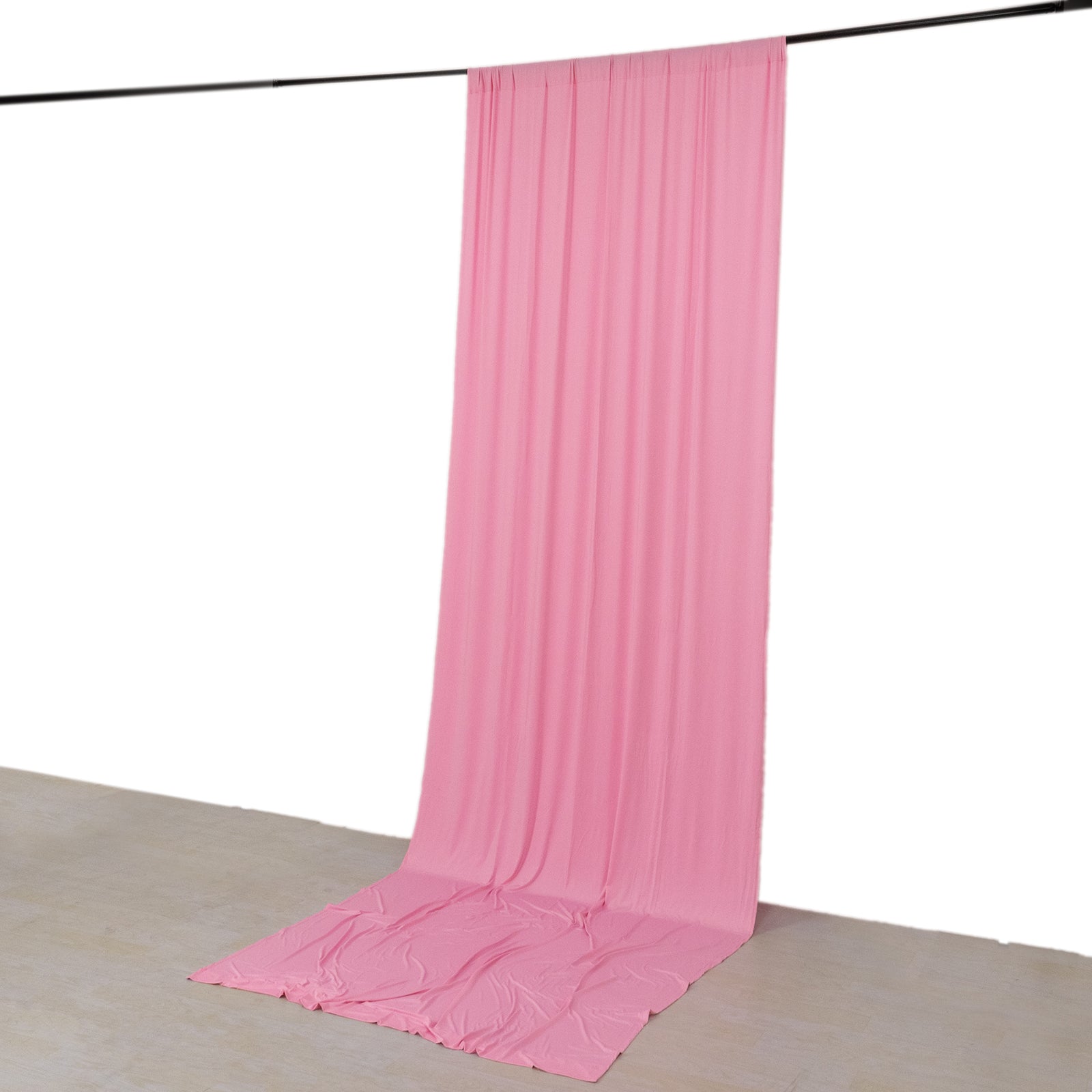 Pink 4-way stretch spandex event curtain drapes hanging as a backdrop.