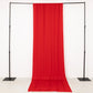 Red 4-way stretch spandex event curtain drapes on a black frame.