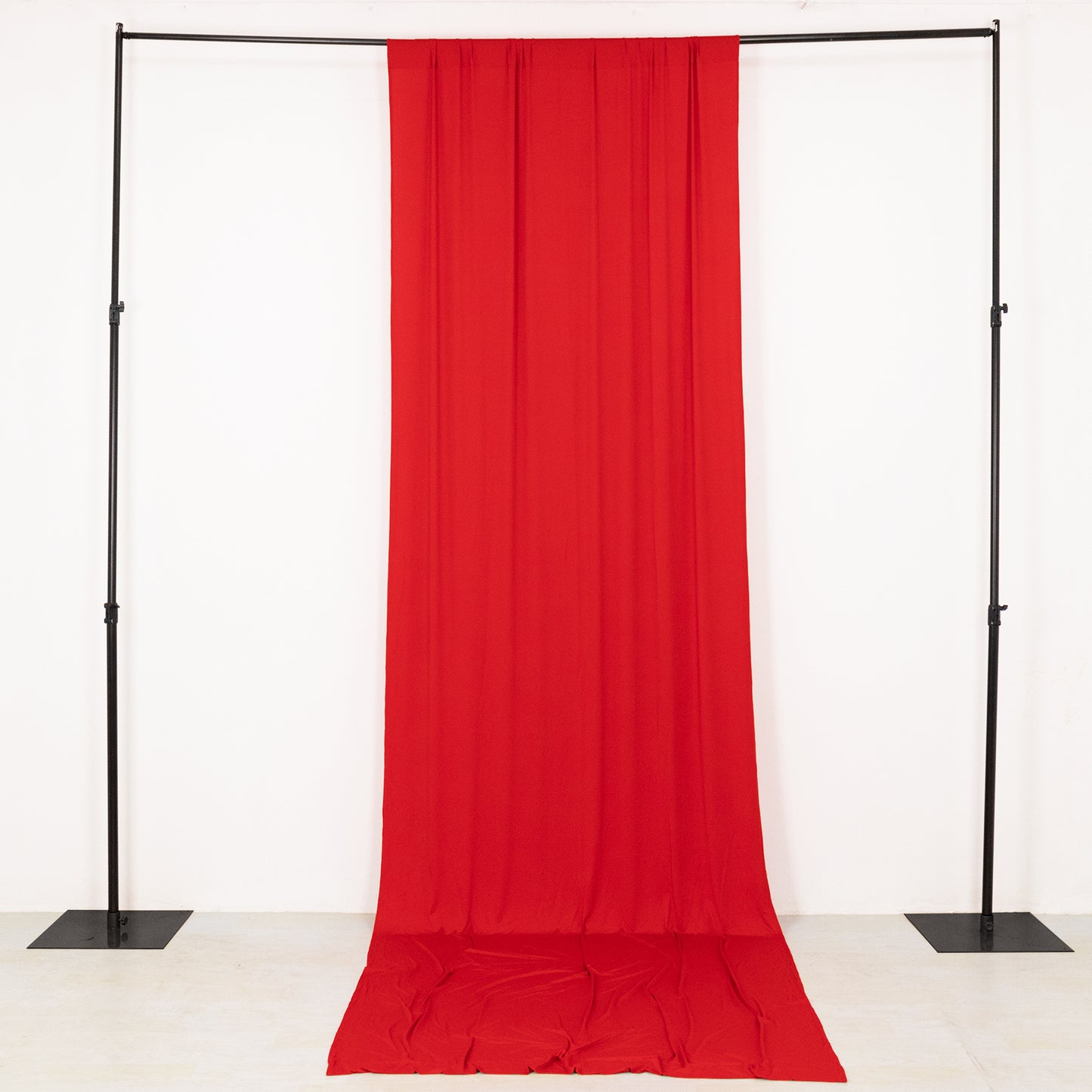 Red 4-way stretch spandex event curtain drapes on a black frame.