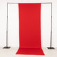 Red 4-way stretch spandex event curtain drapes on a backdrop stand.