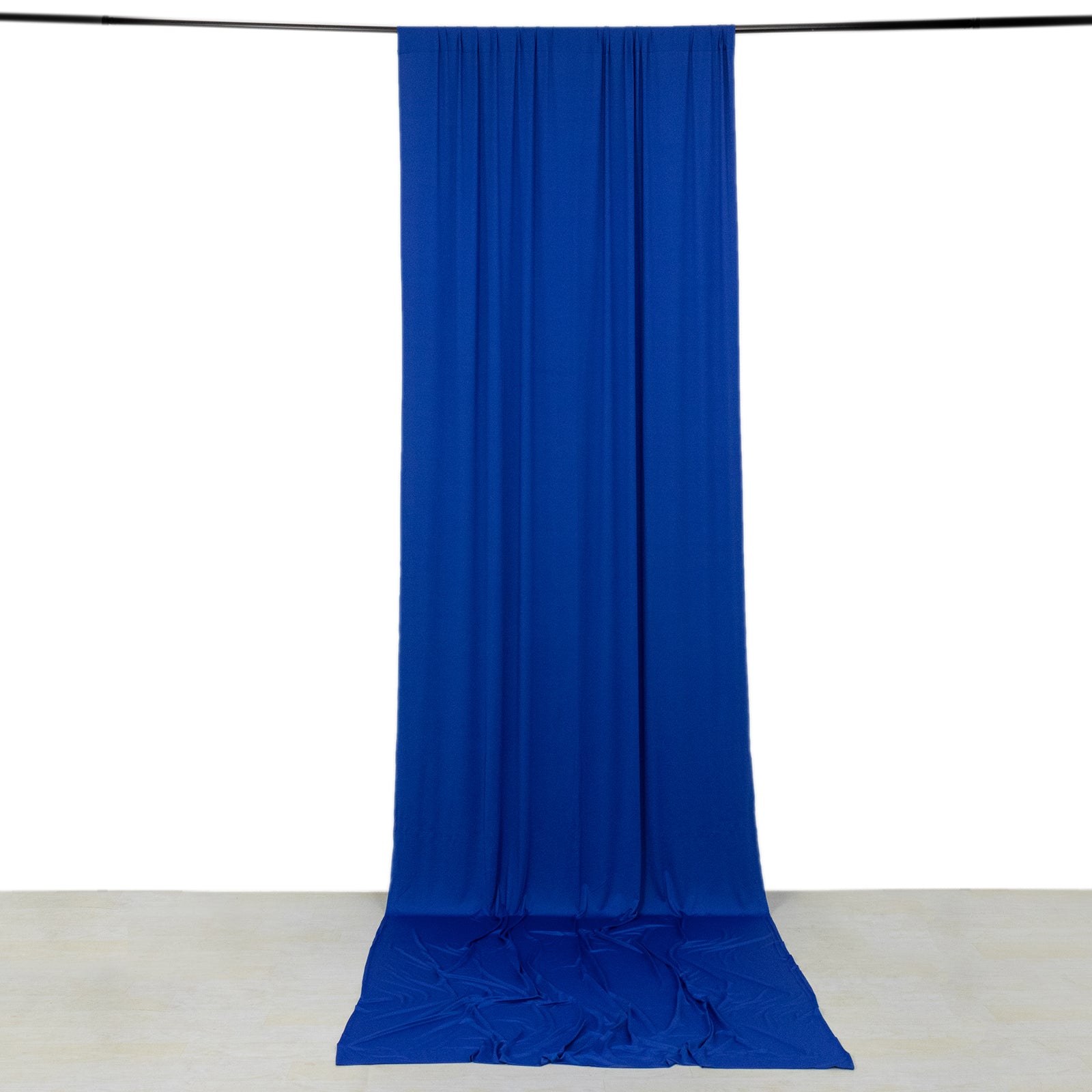 Royal blue 4-way stretch spandex event curtain drapes hanging on a rod.