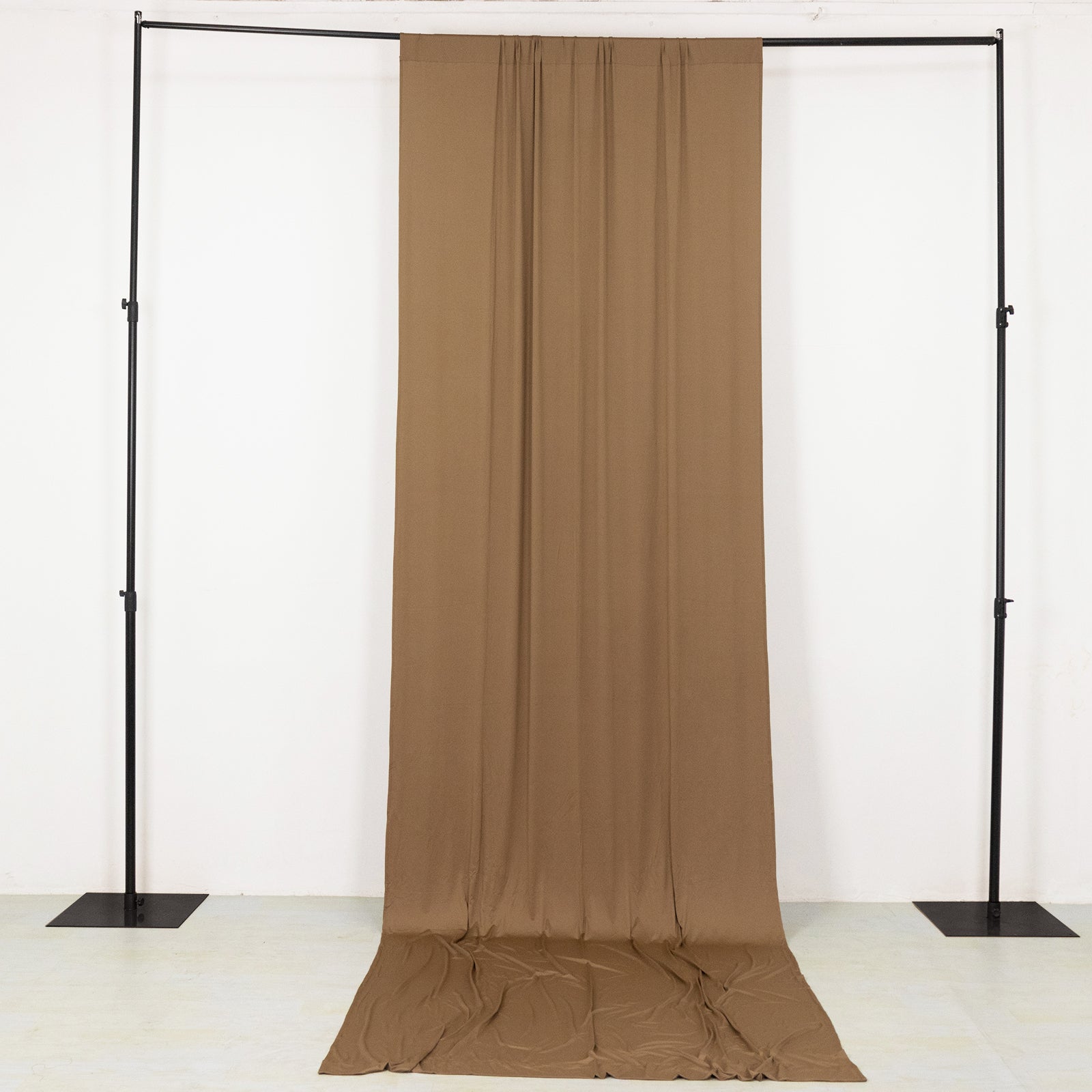 Taupe 4-way stretch spandex event curtain drapes on a backdrop stand.