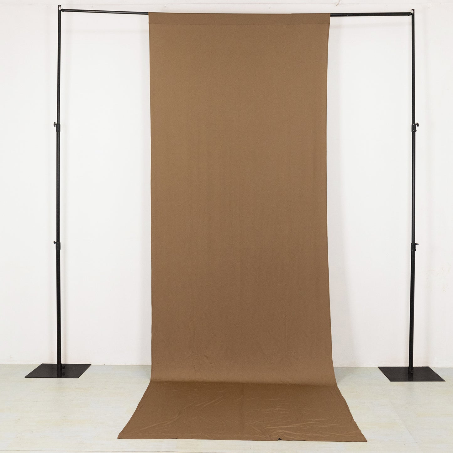 Taupe 4-way stretch spandex event curtain drapes on a backdrop stand.