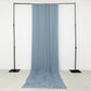 Dusty blue 4-way stretch spandex event curtain drapes on a backdrop stand.