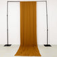 Gold 4-way stretch spandex backdrop curtain drape on black stand.