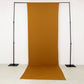 Gold 4-way stretch spandex event curtain drapes on a backdrop stand.