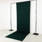 Emerald green 4-way stretch spandex event curtain drapes on a backdrop stand.