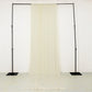 Ivory 4-way stretch spandex event curtain drapes on a black frame.