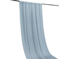 Dusty blue 4-way stretch spandex event curtain drapes on a black rod.