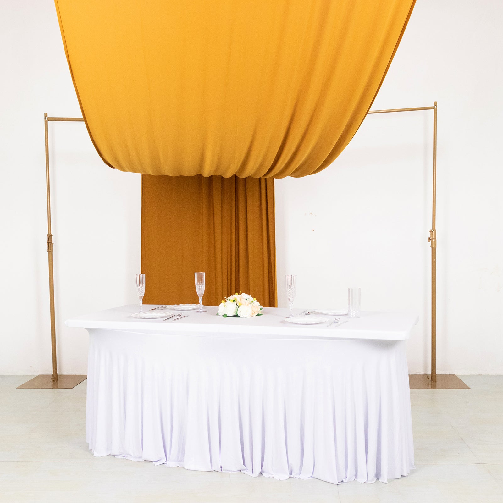 Gold 4-way stretch spandex event curtain drapes with rod pockets.
