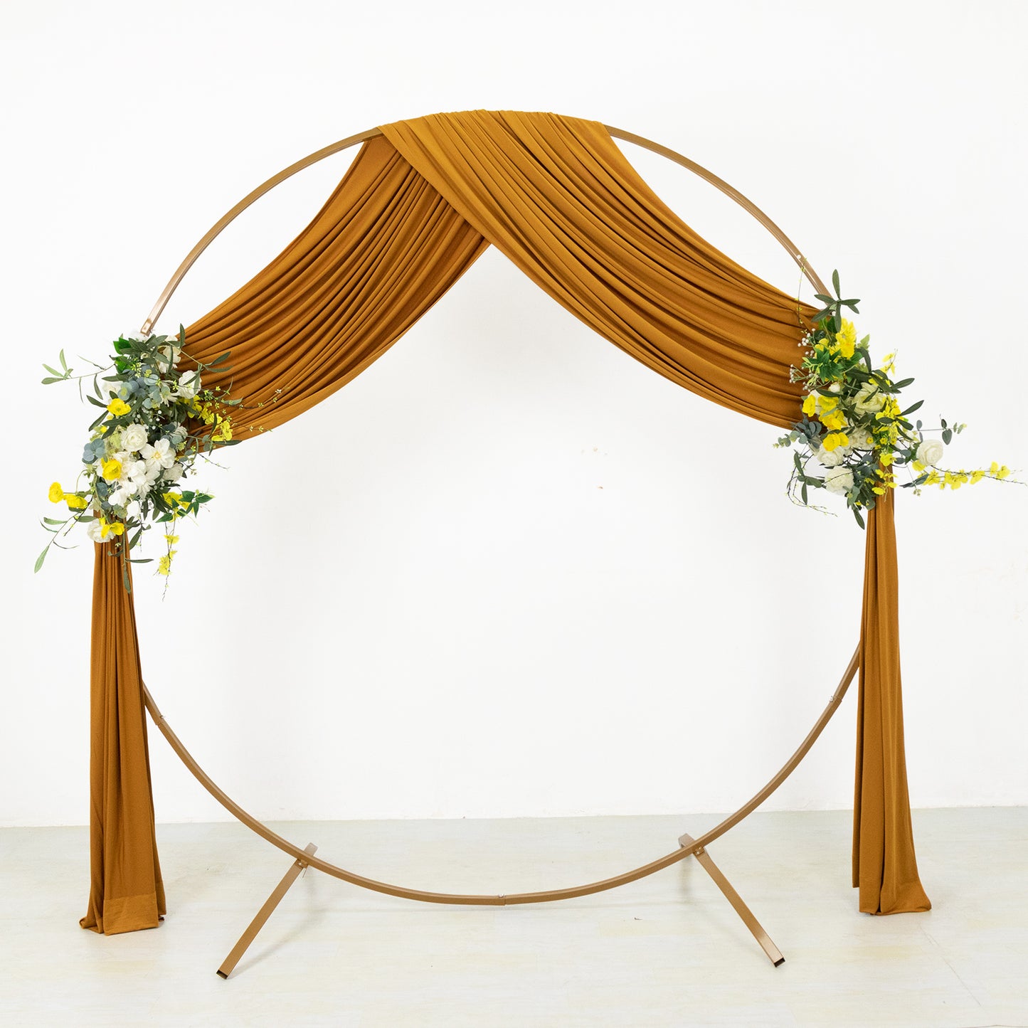 Gold 4-way stretch spandex drapes with floral accents on a circular backdrop.