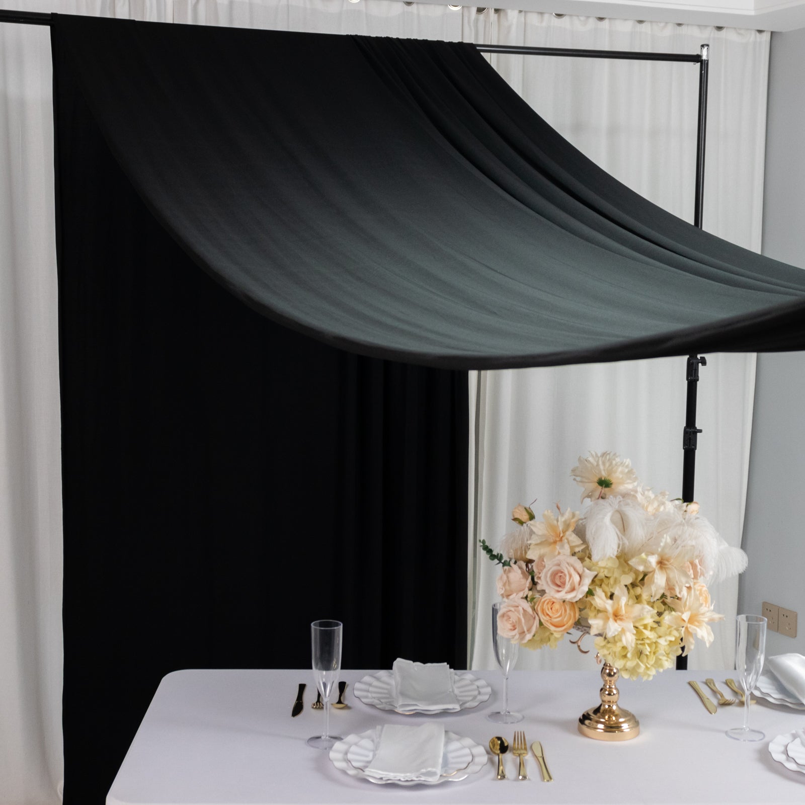 Black 4-way stretch spandex backdrop drapes for events.