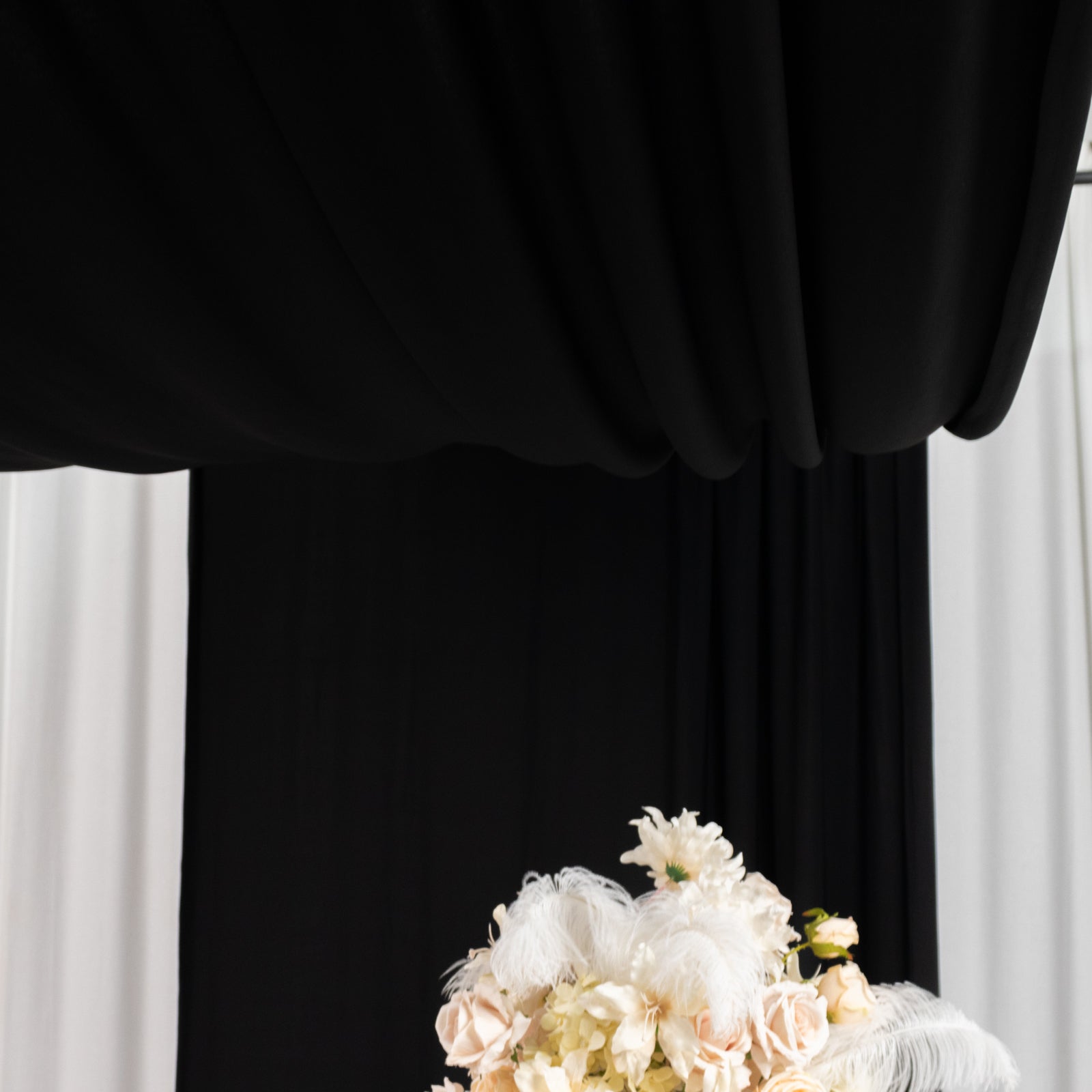 Black 4-way stretch spandex event curtain drapes backdrop panel.