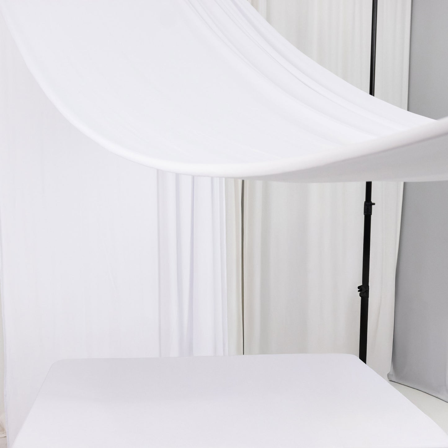 White 4-way stretch spandex event curtain drapes backdrop panel.