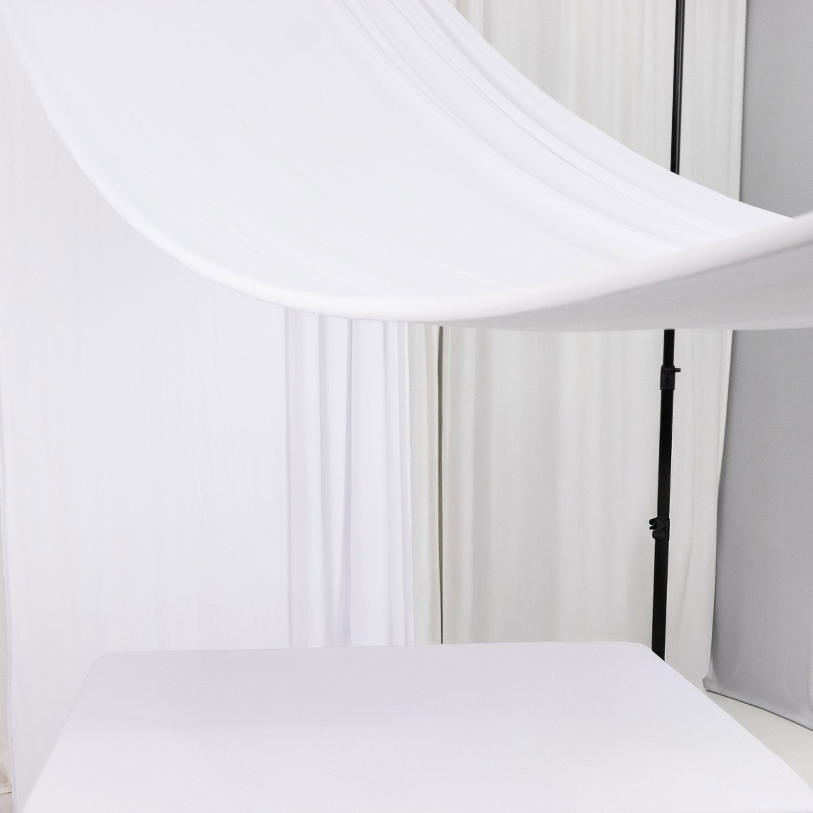 White 4-way stretch spandex event curtain drapes backdrop panel.